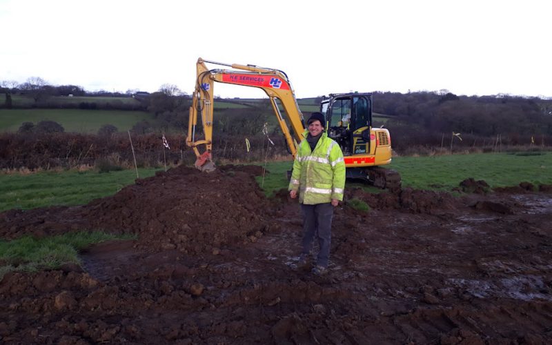 In February 2021 we took two diggers in and stripped turf, built banks and dug ponds. This was the main intervention, designed to start the process of letting nature back into the fields. view over the field as the diggers were creating the new nature friendly environment - there's lots of soil showing and marker canes